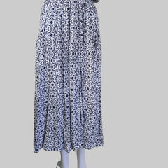 Stack of folded fabric with a geometric pattern on a white surface.