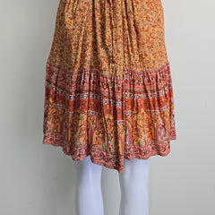 Orange patterned dress on a light background