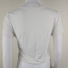 White top on a mannequin against a plain background