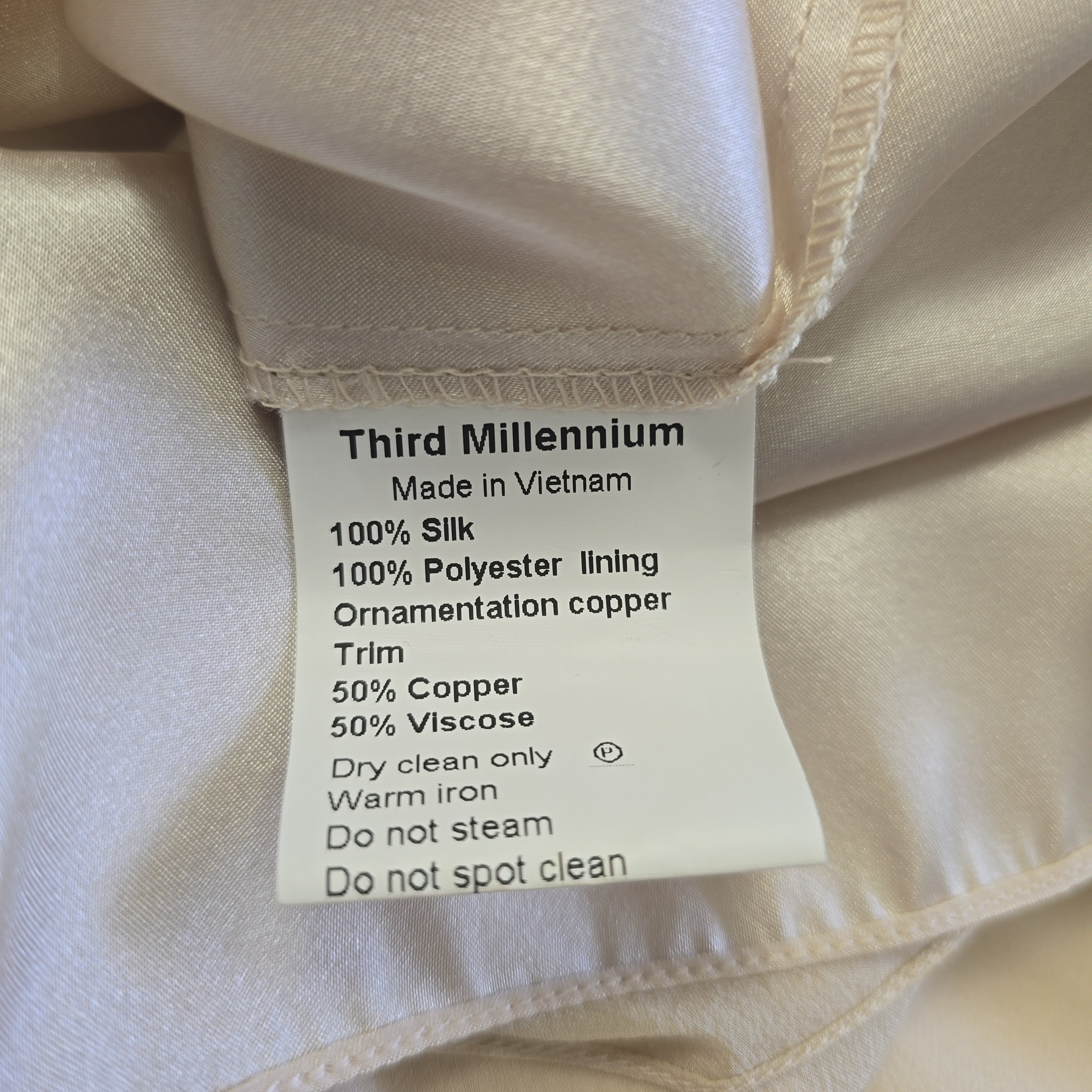 Fabric tag with material details on a beige fabric background