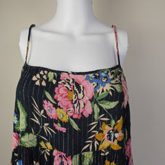 Floral embroidered fabric on a mannequin with a plain background