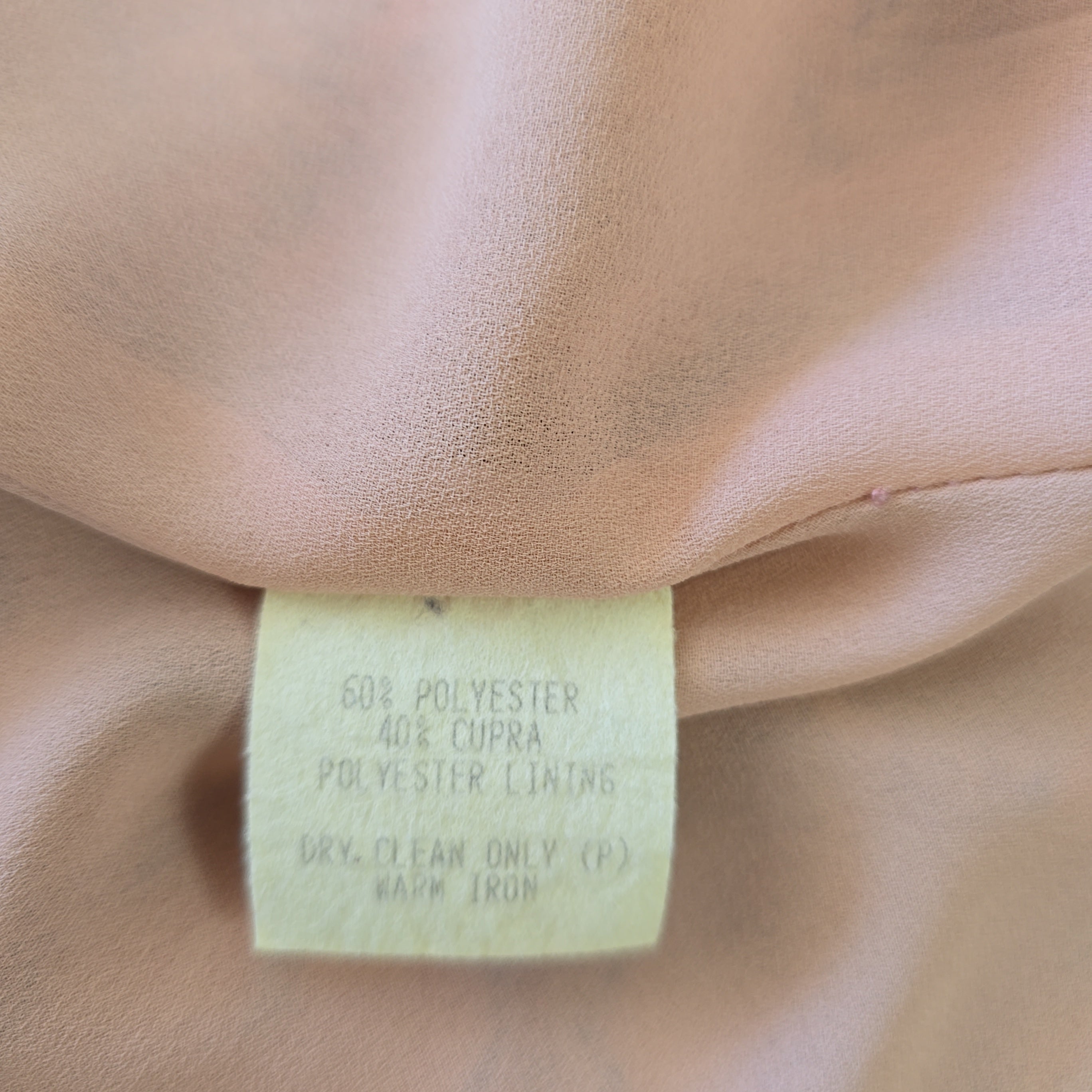 Close-up of a fabric tag on beige fabric