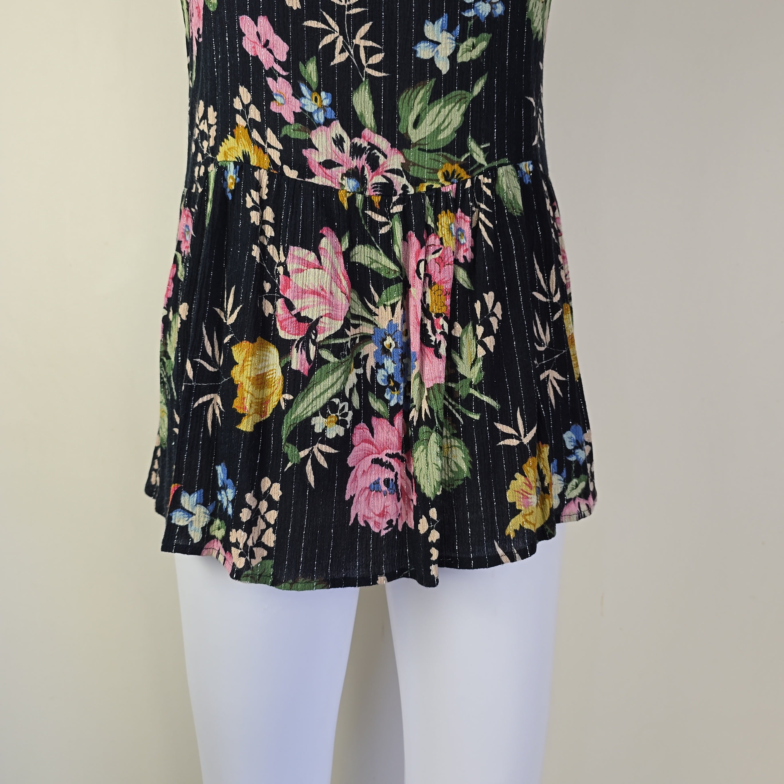 Black floral-patterned top on a light background