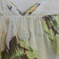 Close-up of a fabric product with a brand label, featuring a floral pattern.