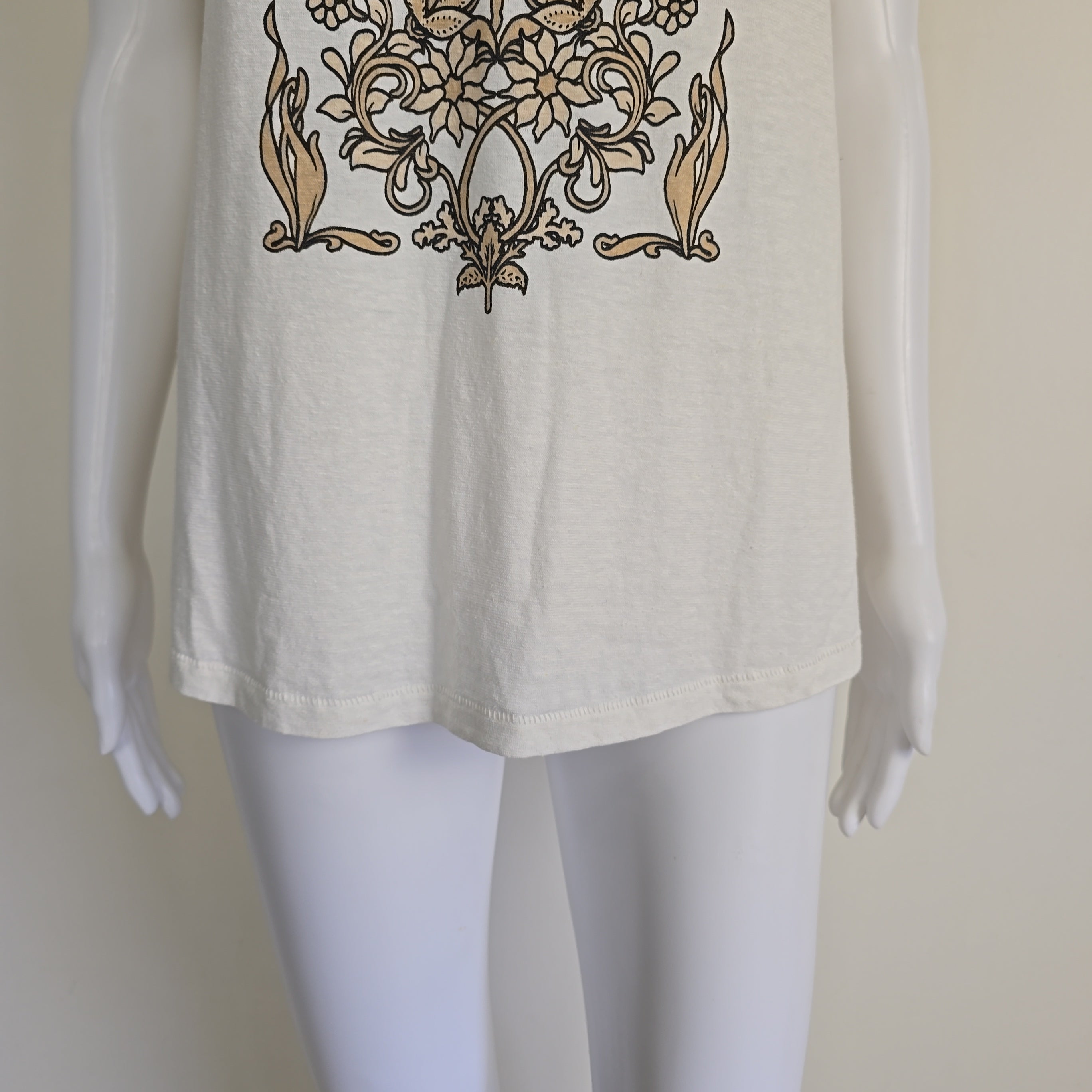 White t-shirt with floral design and text on a light background