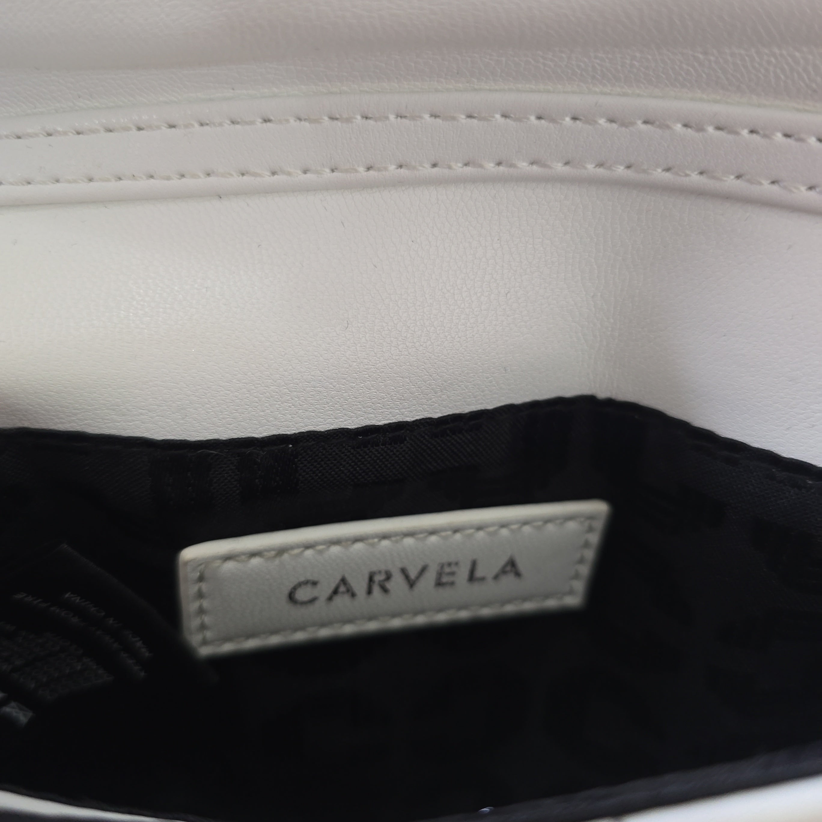 Close-up of a Carvela label on a product with a white background