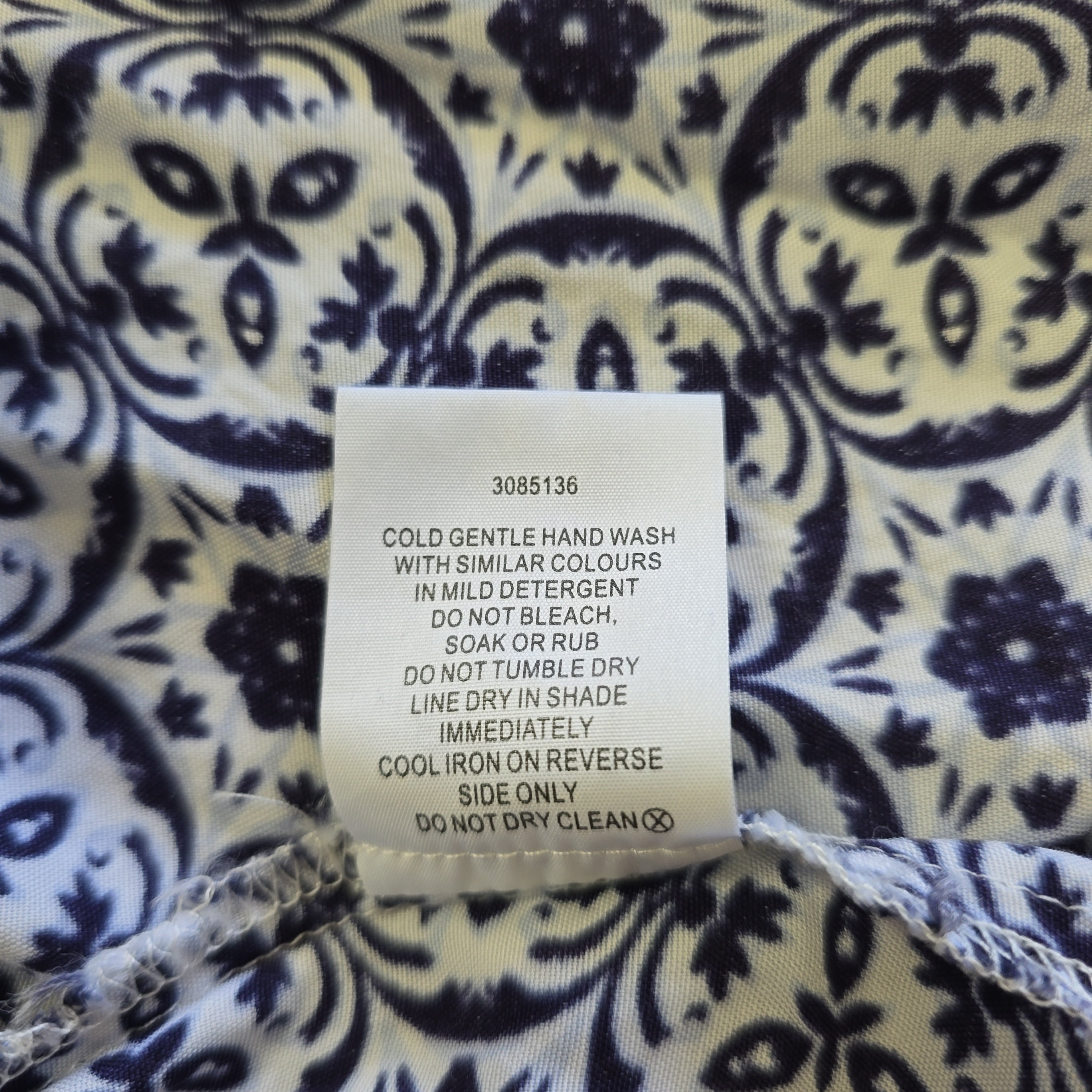 Clothing label on a fabric with blue and white pattern