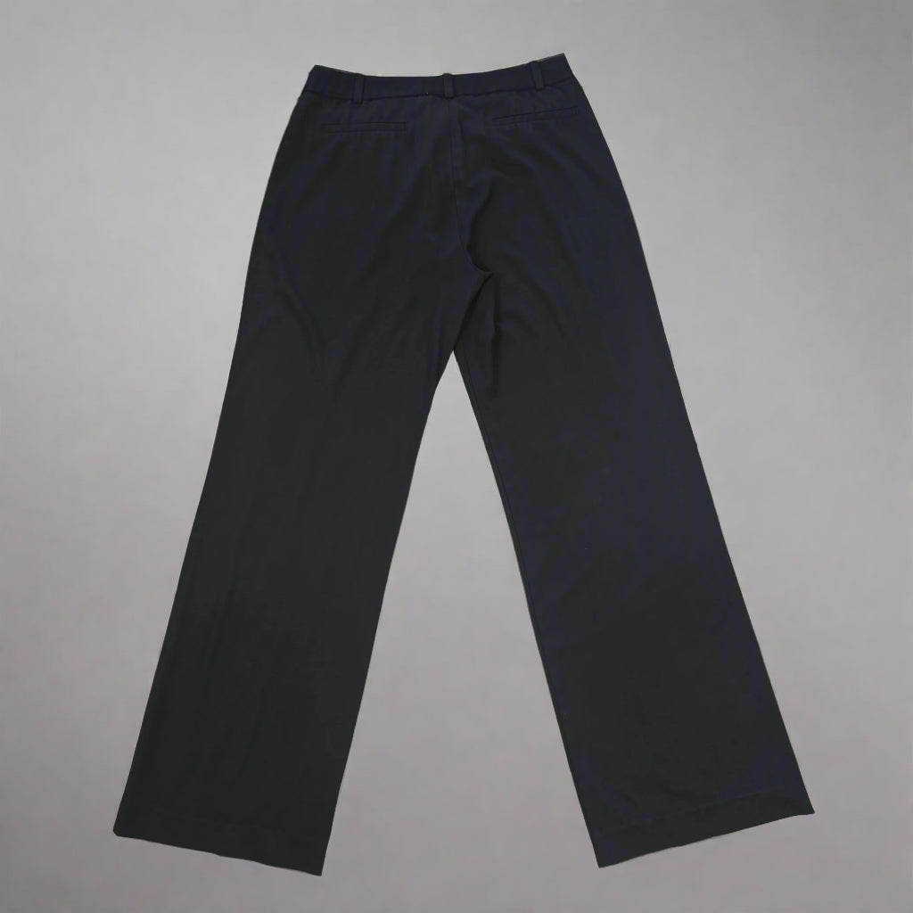 Black pants on a tiled floor