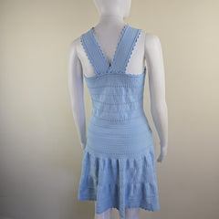 Light blue knitted dress with ruffled straps on a mannequin against a plain background