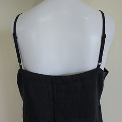 Black top on a mannequin with a plain background