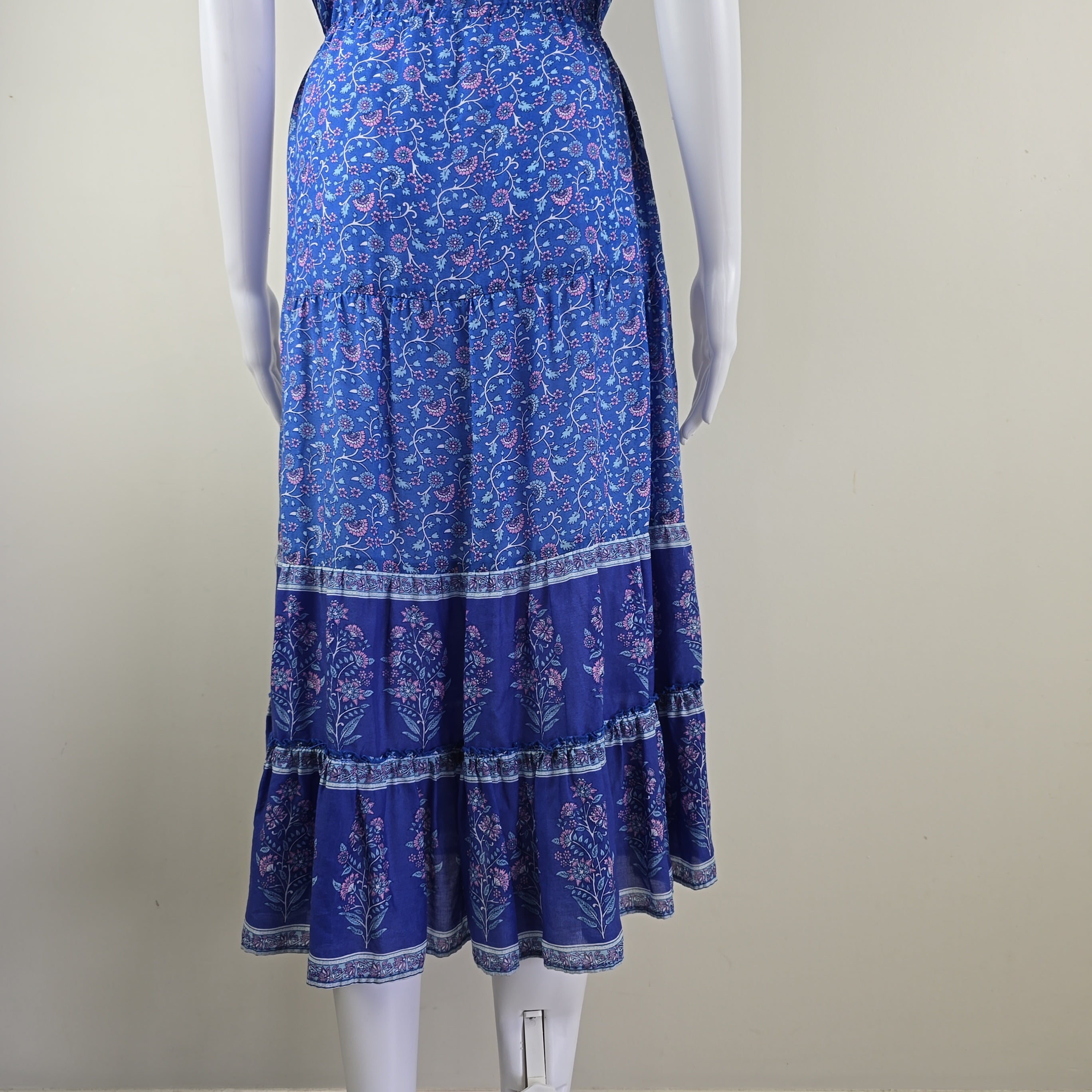 Blue floral-patterned skirt on a mannequin against a plain background