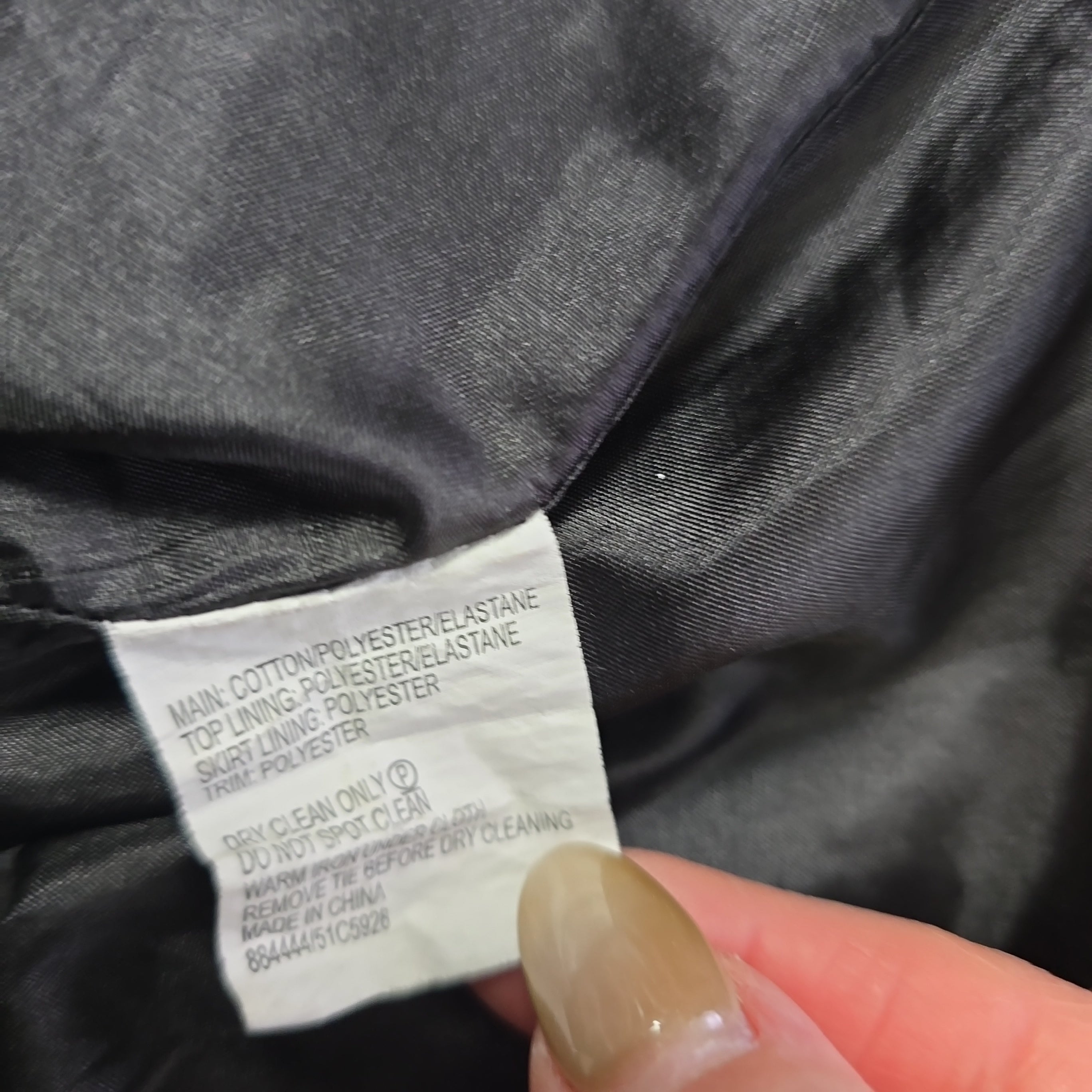 Close-up of a clothing label on a dark fabric background