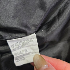 Close-up of a clothing label on a dark fabric background