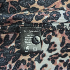 Leopard print fabric with a label on a close-up of the pattern