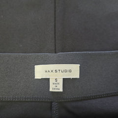 Black fabric with a 'MAX STUDIO' label on a dark background