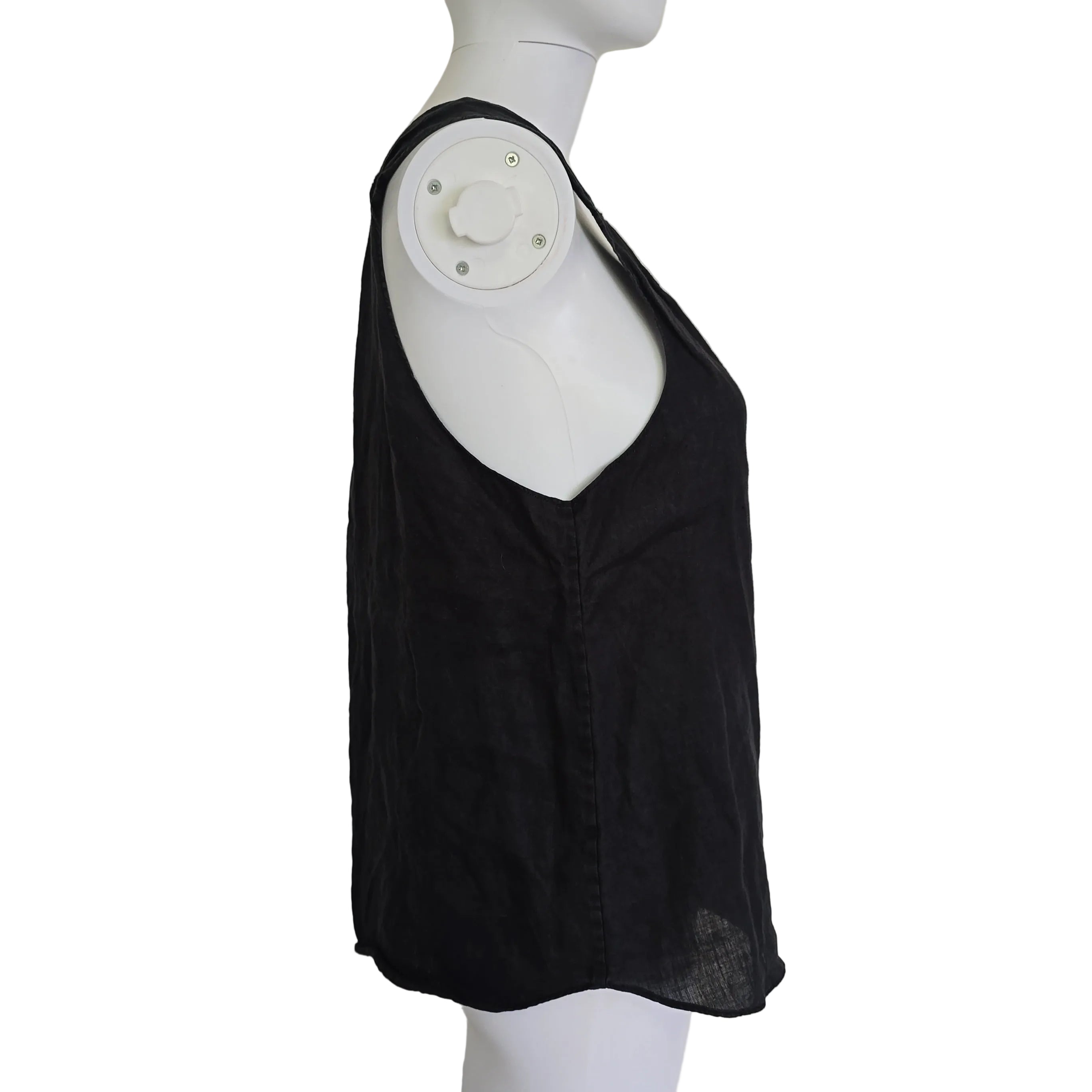Black top on a white mannequin against a light background