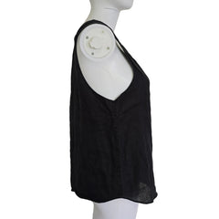 Black top on a white mannequin against a light background