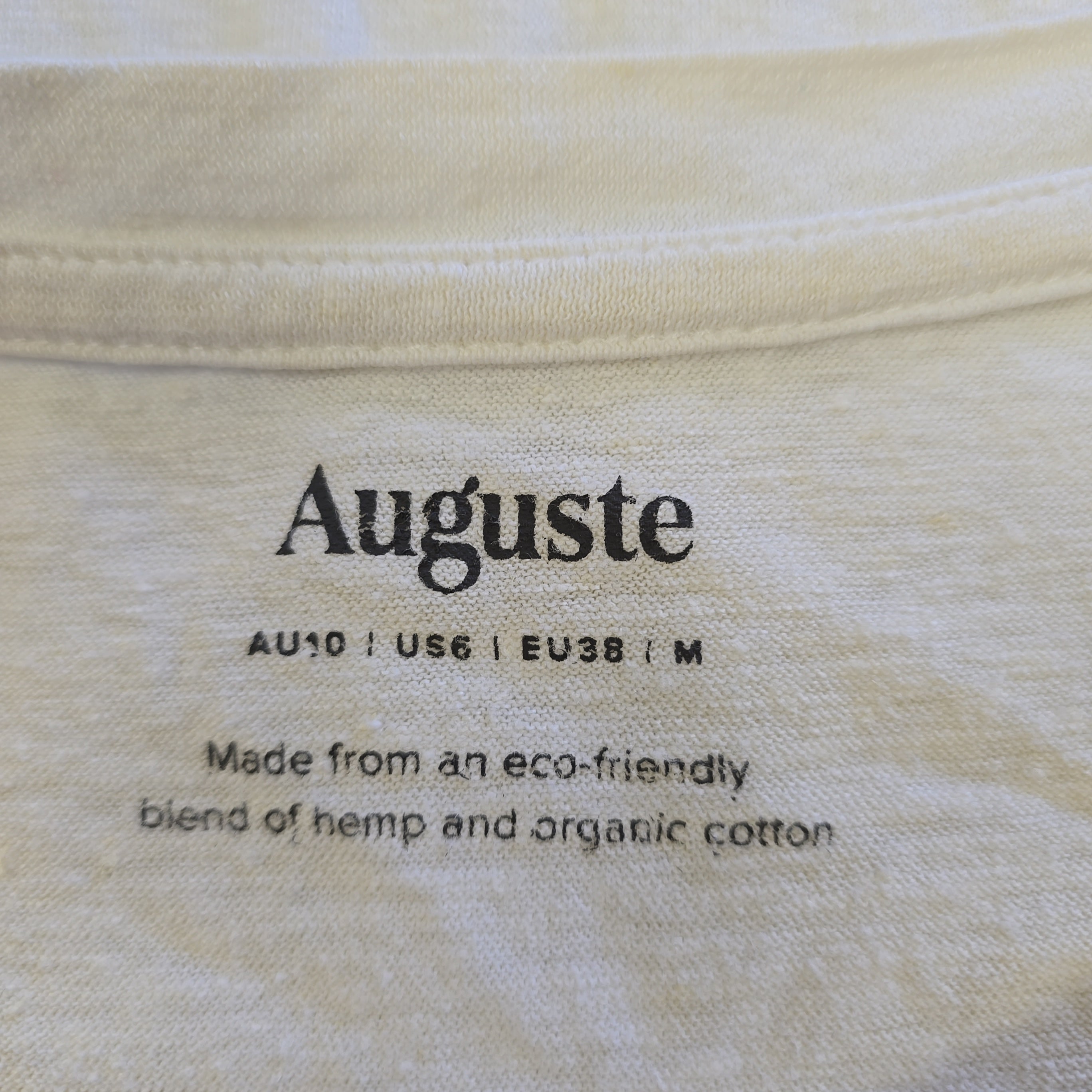 Text on fabric indicating 'Auguste' brand with eco-friendly material information.