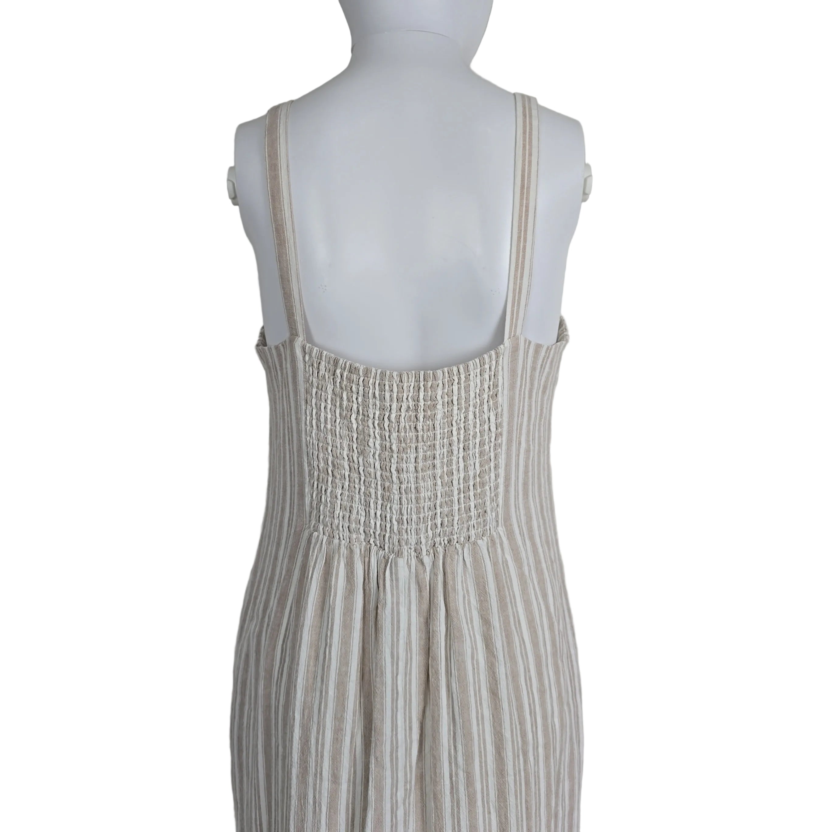 Mannequin wearing a textured dress with a neutral background