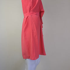 Pink dress on a mannequin against a plain background