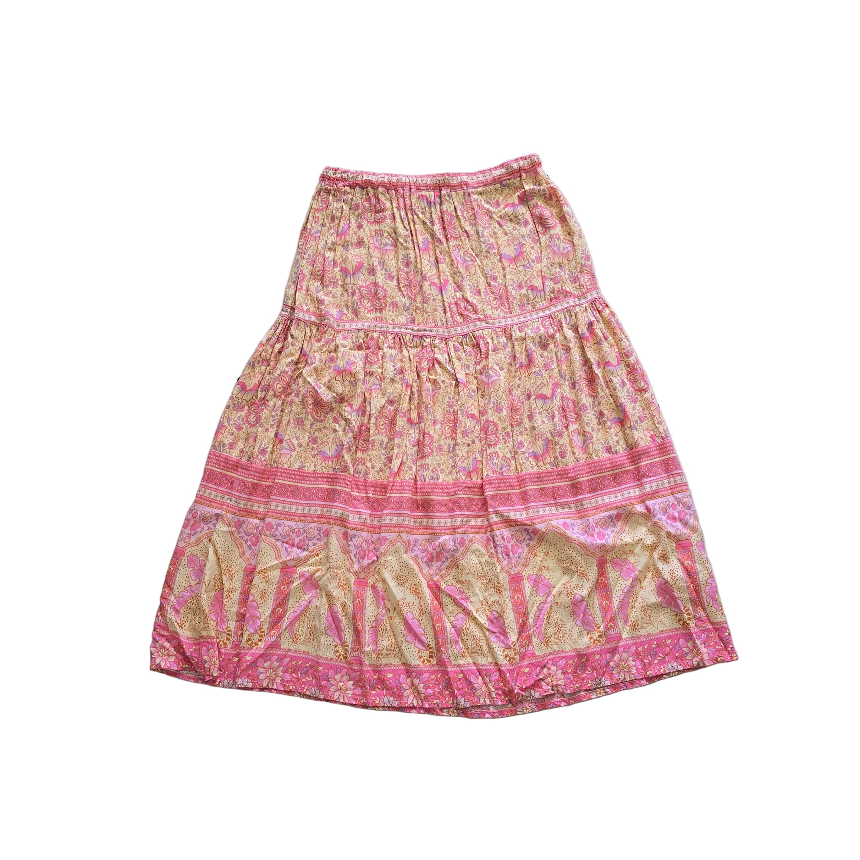 Pink and gold patterned skirt on a light background