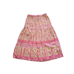 Pink and gold patterned skirt on a light background