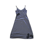 Grey dress with black floral patterns on a light background.