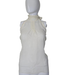 White top on a mannequin against a plain background