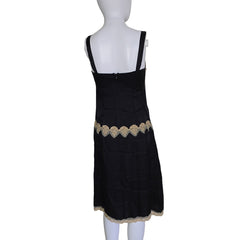 Black dress with lace details on a mannequin against a white background