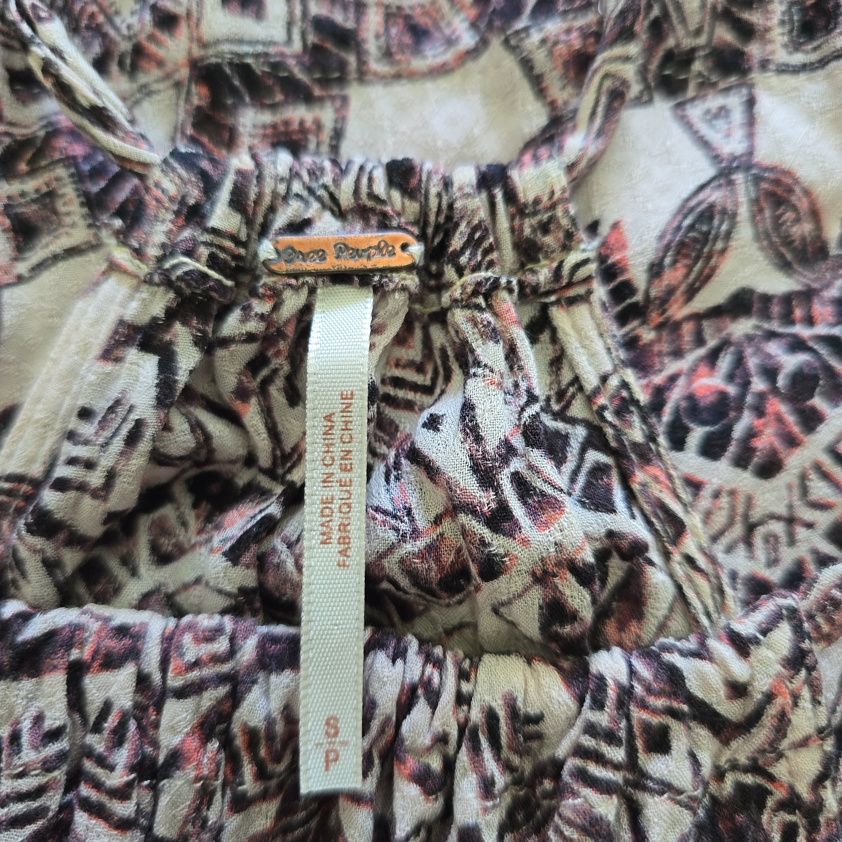 Close-up of patterned fabric with a label on a white background