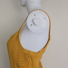 Yellow knitted tank top on a light background