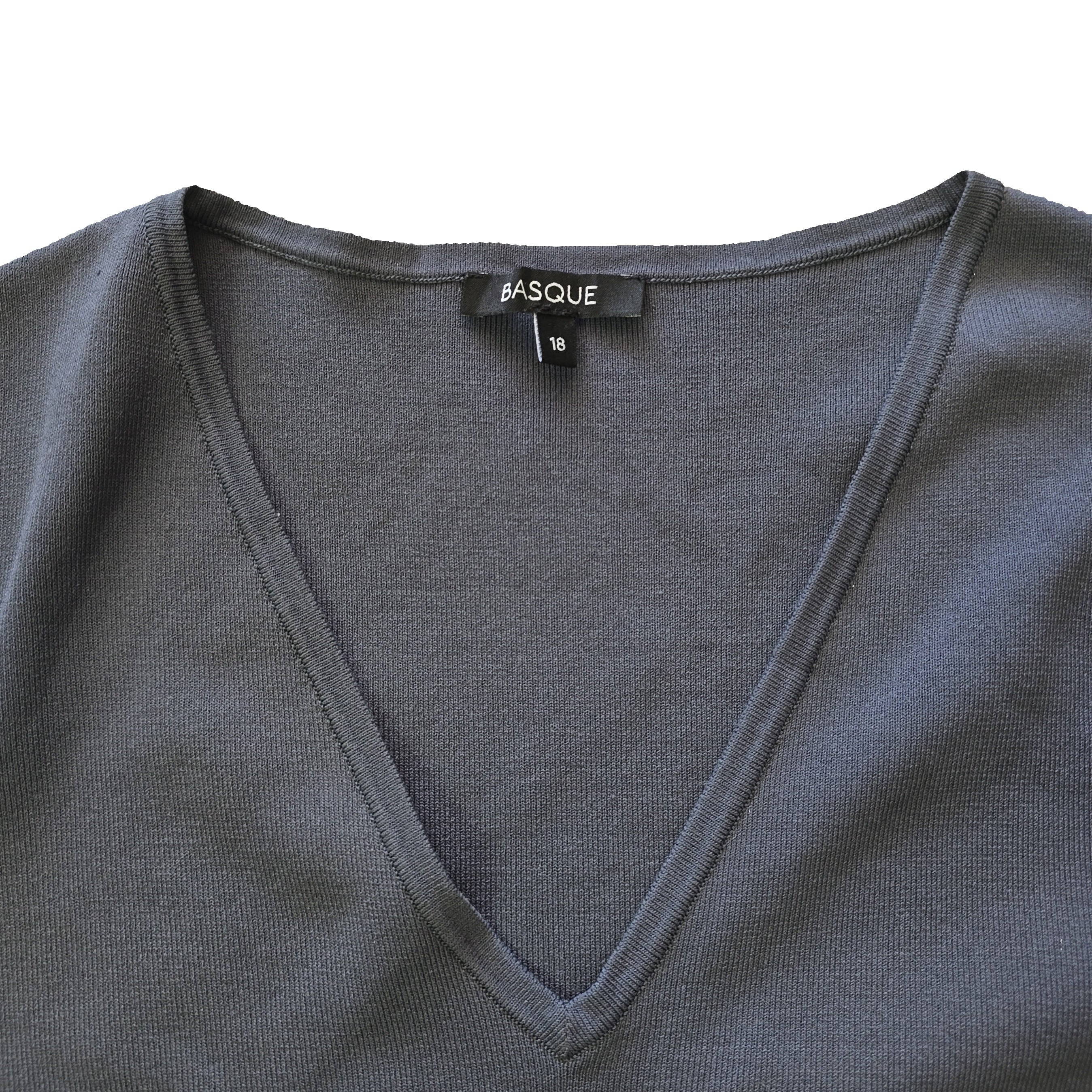 Gray garment with a visible brand label on a yellow background