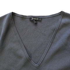 Gray garment with a visible brand label on a yellow background