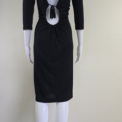 Black dress on a mannequin against a plain background