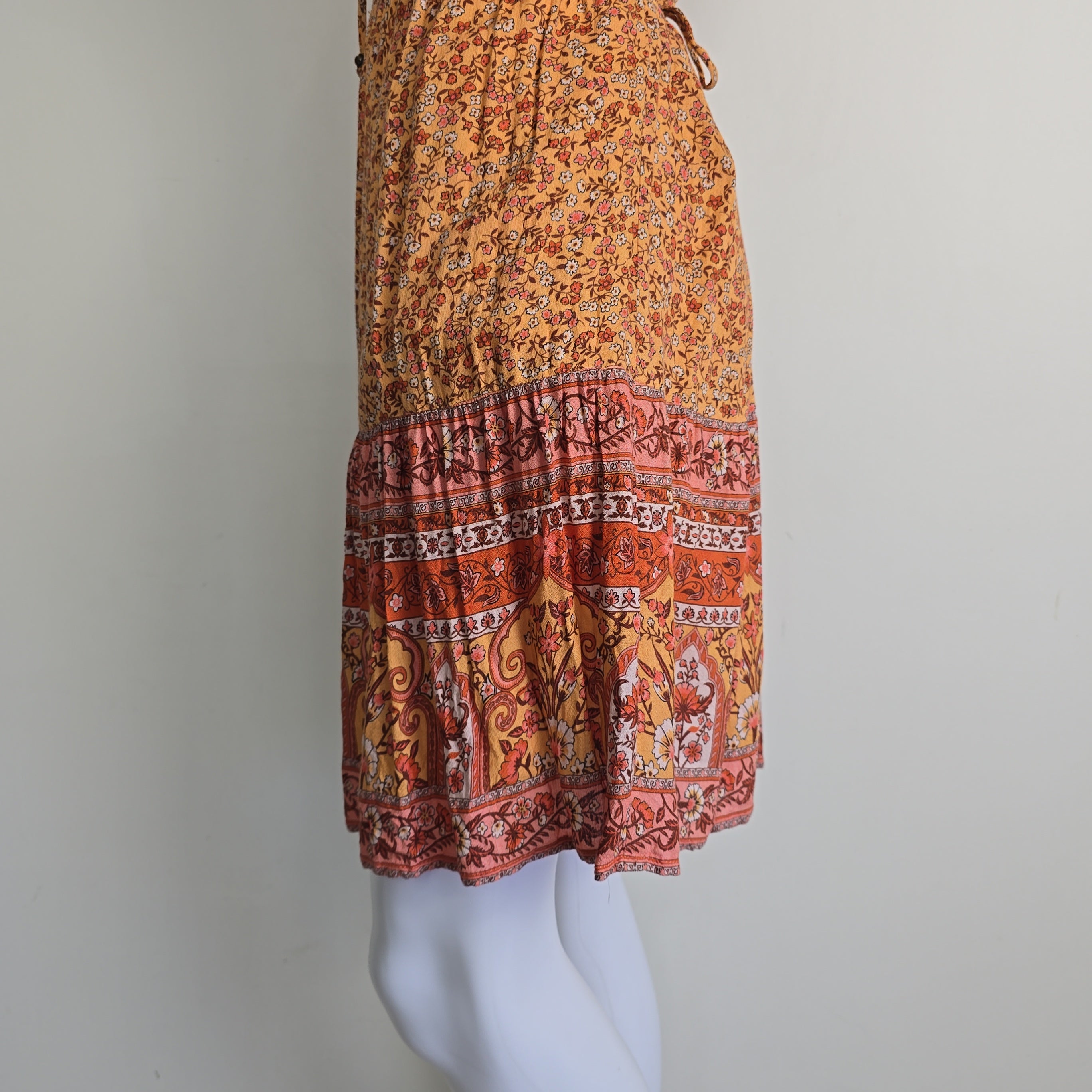 Orange patterned dress on a light background