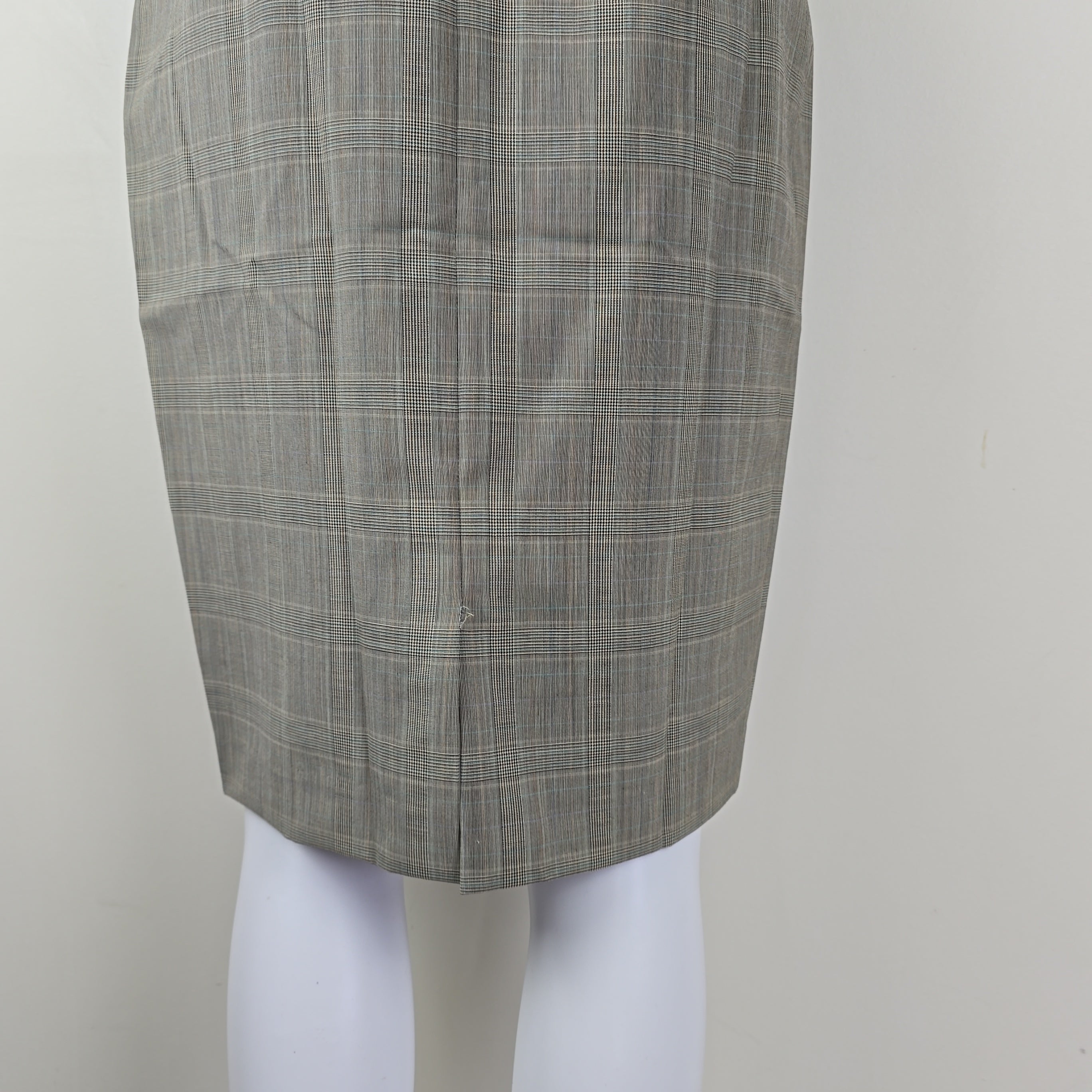 Gray checkered skirt roll on a mannequin with a plain background