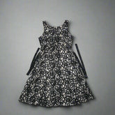 Black and white patterned dress on a tiled floor