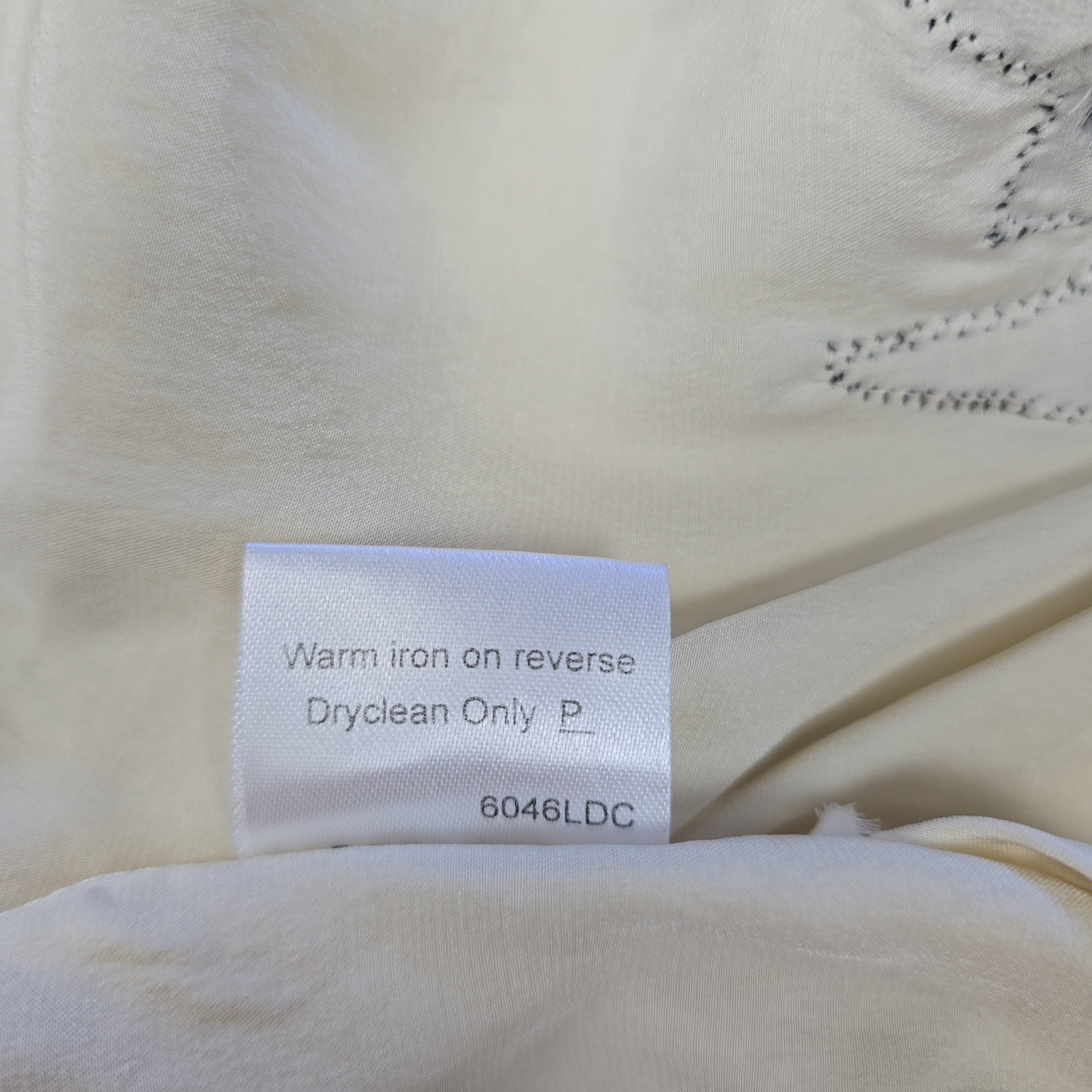 Fabric with a care label on a beige background