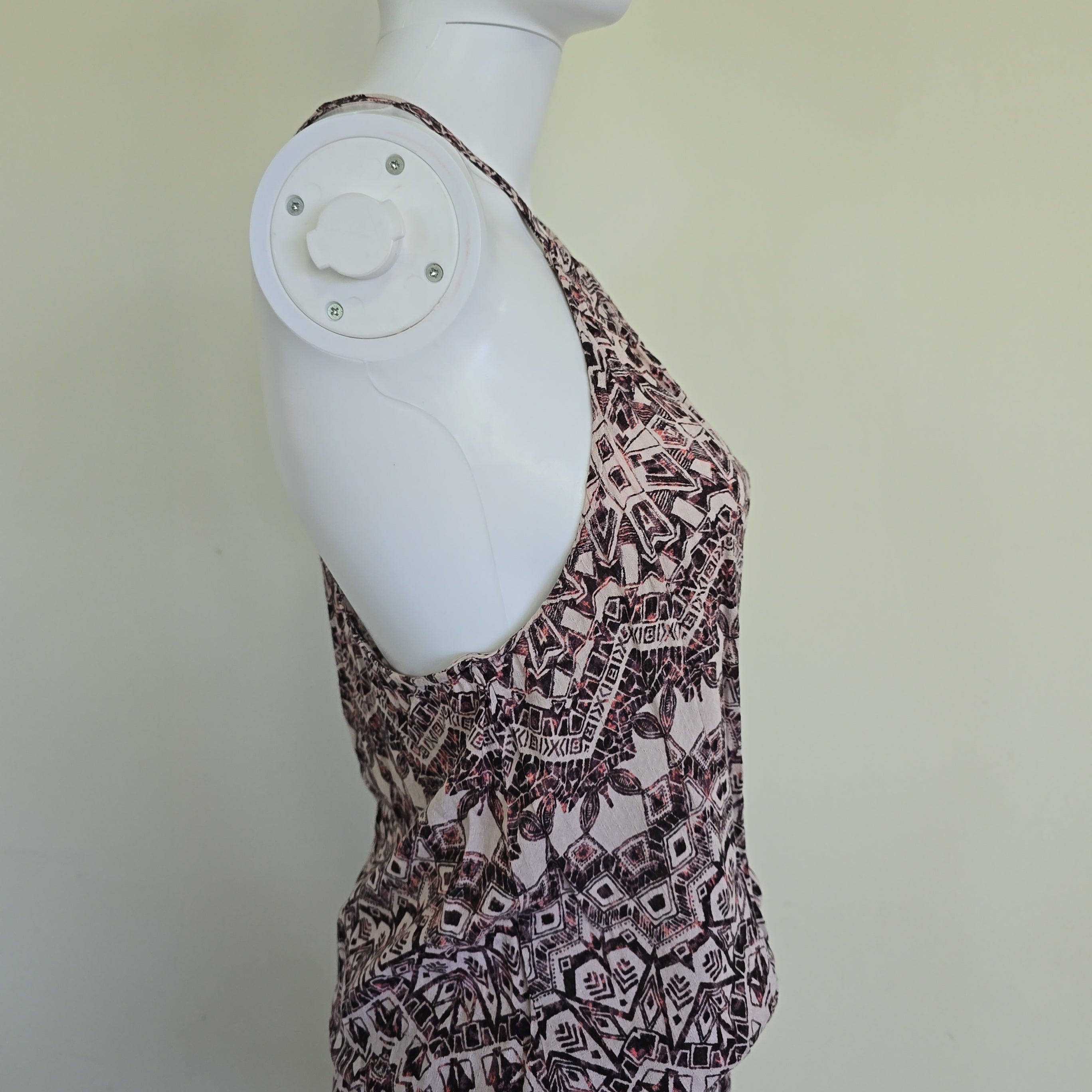Mannequin wearing a patterned dress with a plain background
