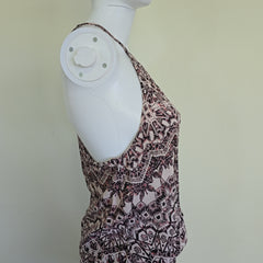 Mannequin wearing a patterned dress with a plain background