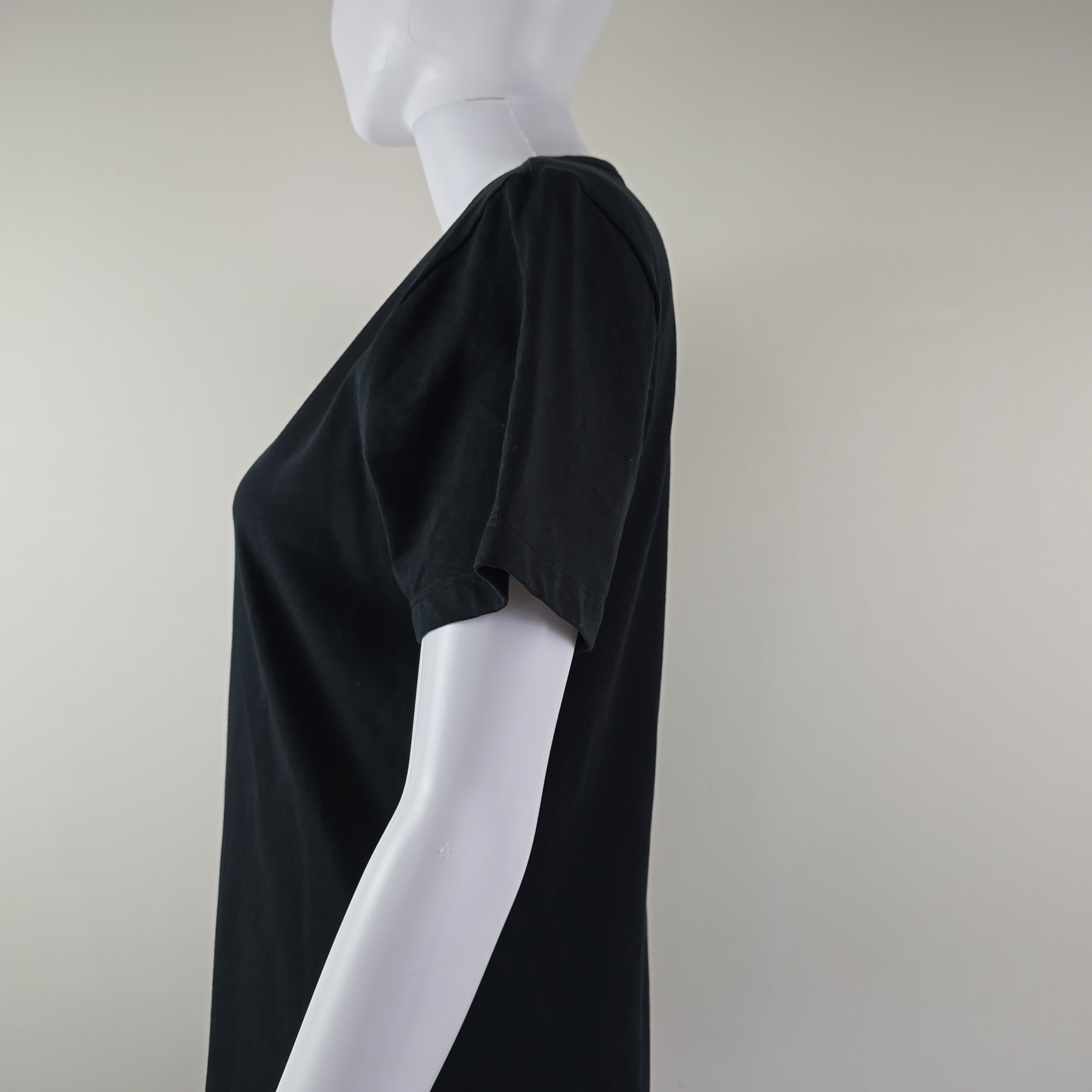 Black t-shirt dress with DKNY logo on a light background