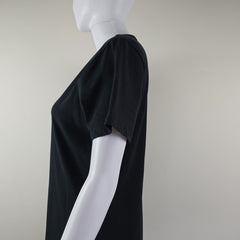 Black t-shirt dress with DKNY logo on a light background