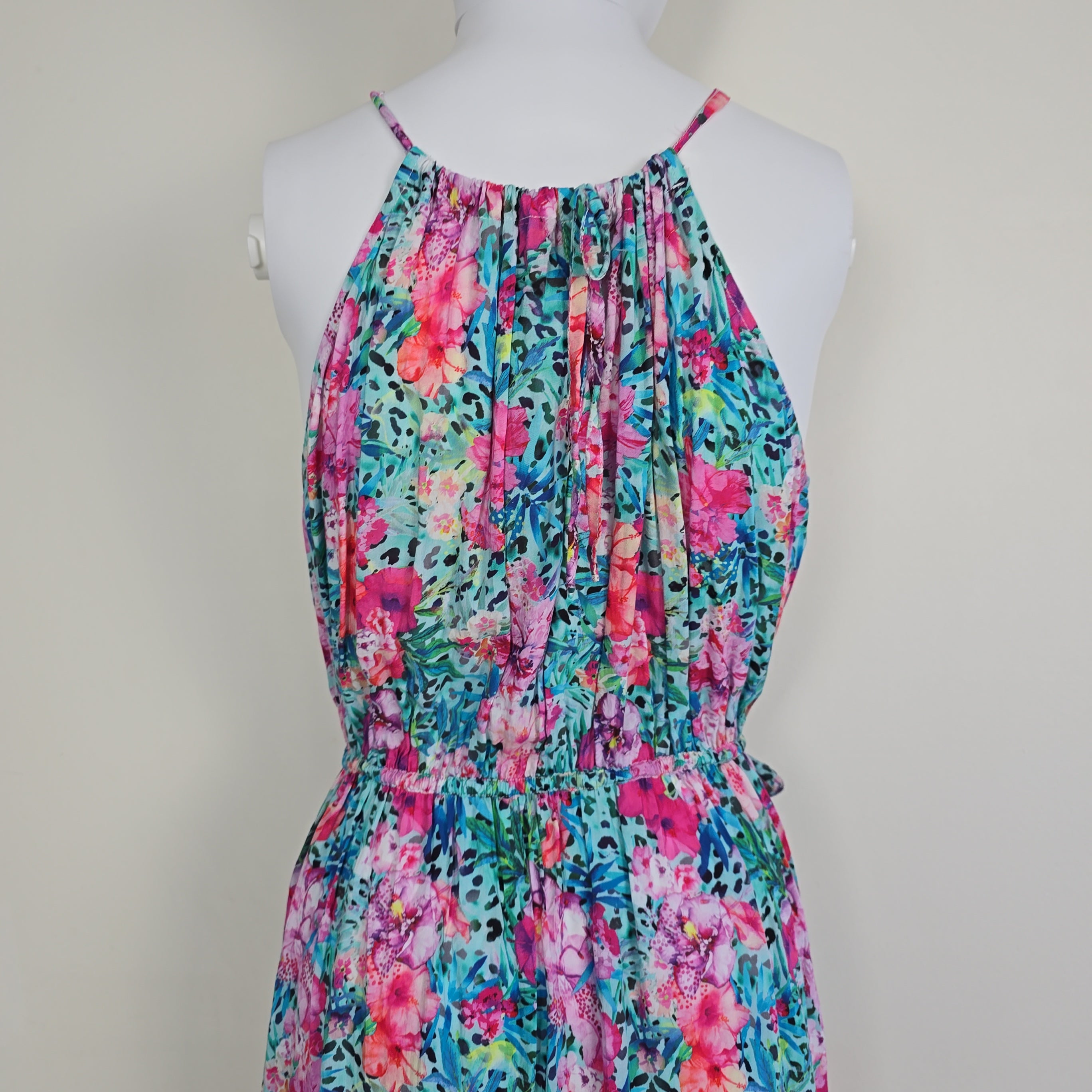 Floral strapless dress on a mannequin against a plain background