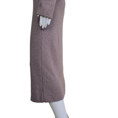 Plum coloured dress with silver details on a light background