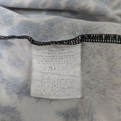 Close-up of a label on a piece of fabric with text and numbers.