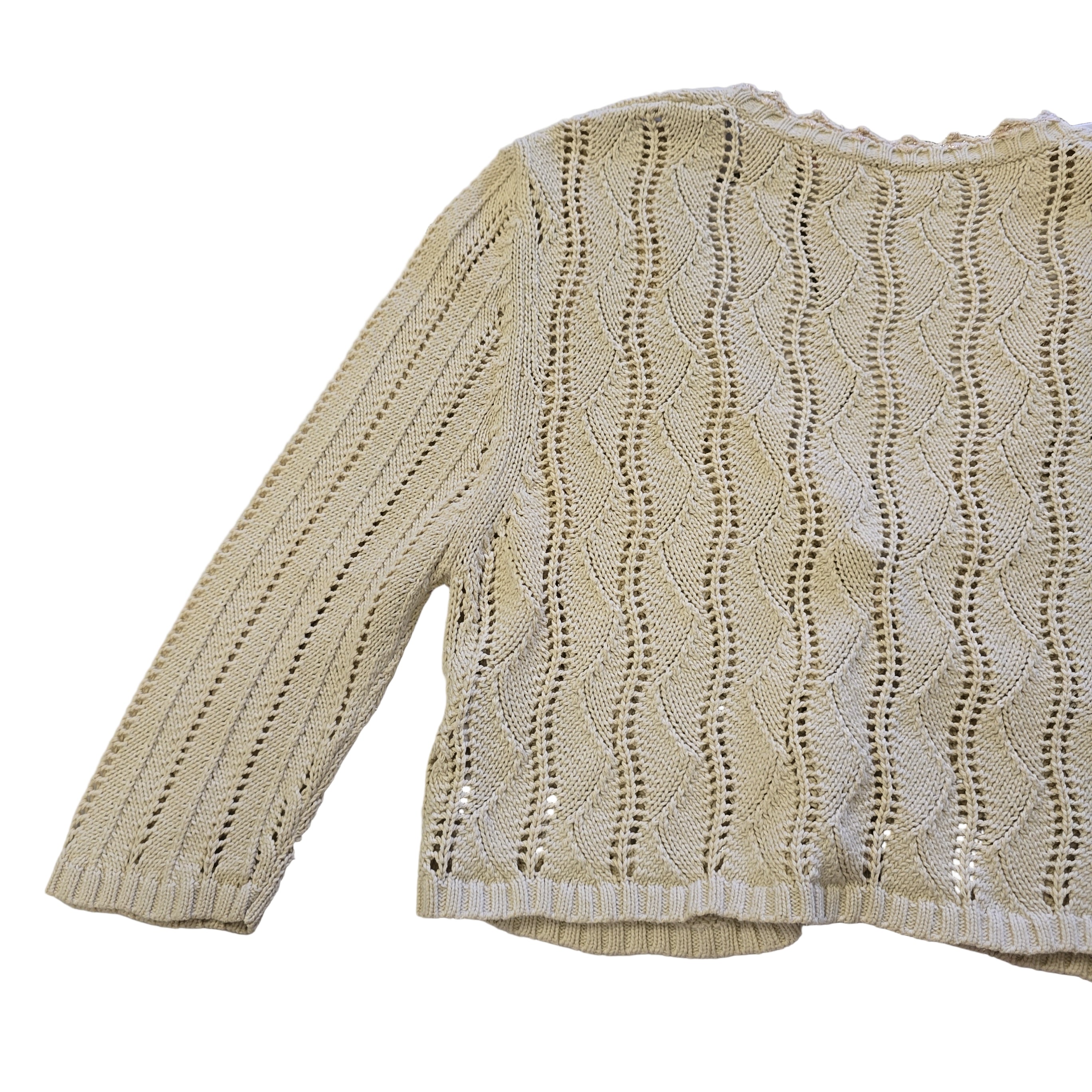 Beige knitted garment on a tiled floor