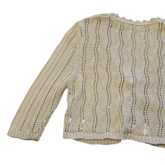 Beige knitted garment on a tiled floor