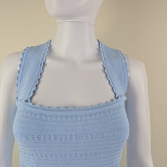 Light blue textured btop on a mannequin against a beige background