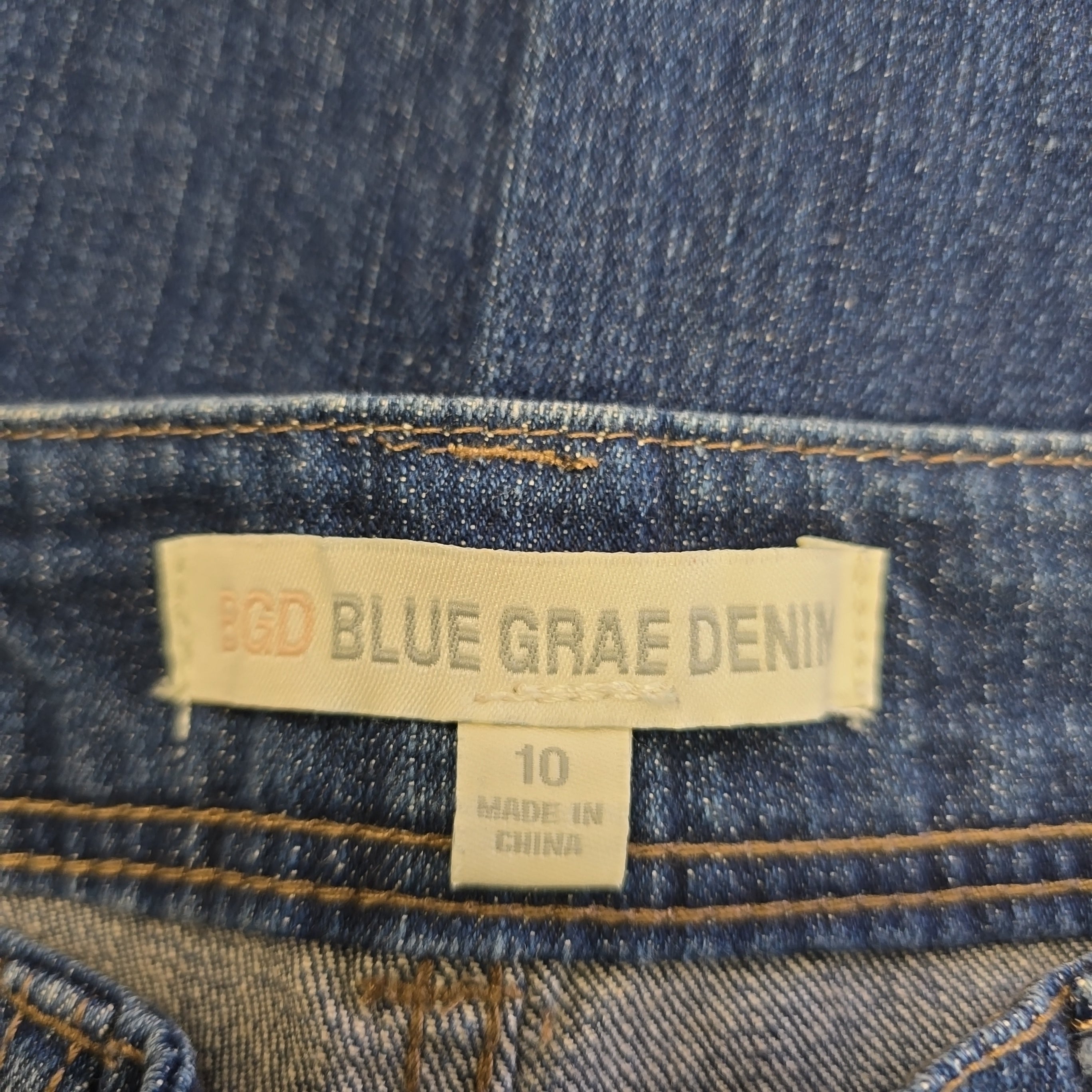 Close-up of a Blue Grae Denim label on denim fabric.