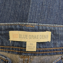 Close-up of a Blue Grae Denim label on denim fabric.
